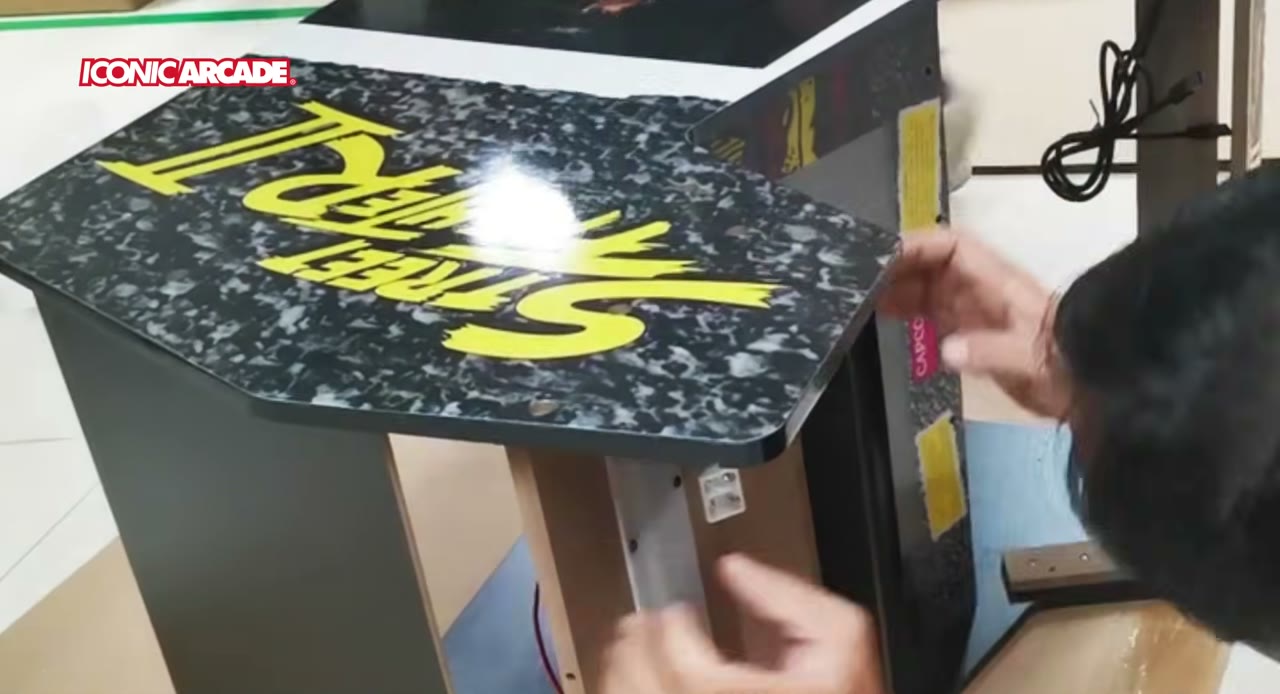 The Street Fighter II XT control panel overlay being fitted